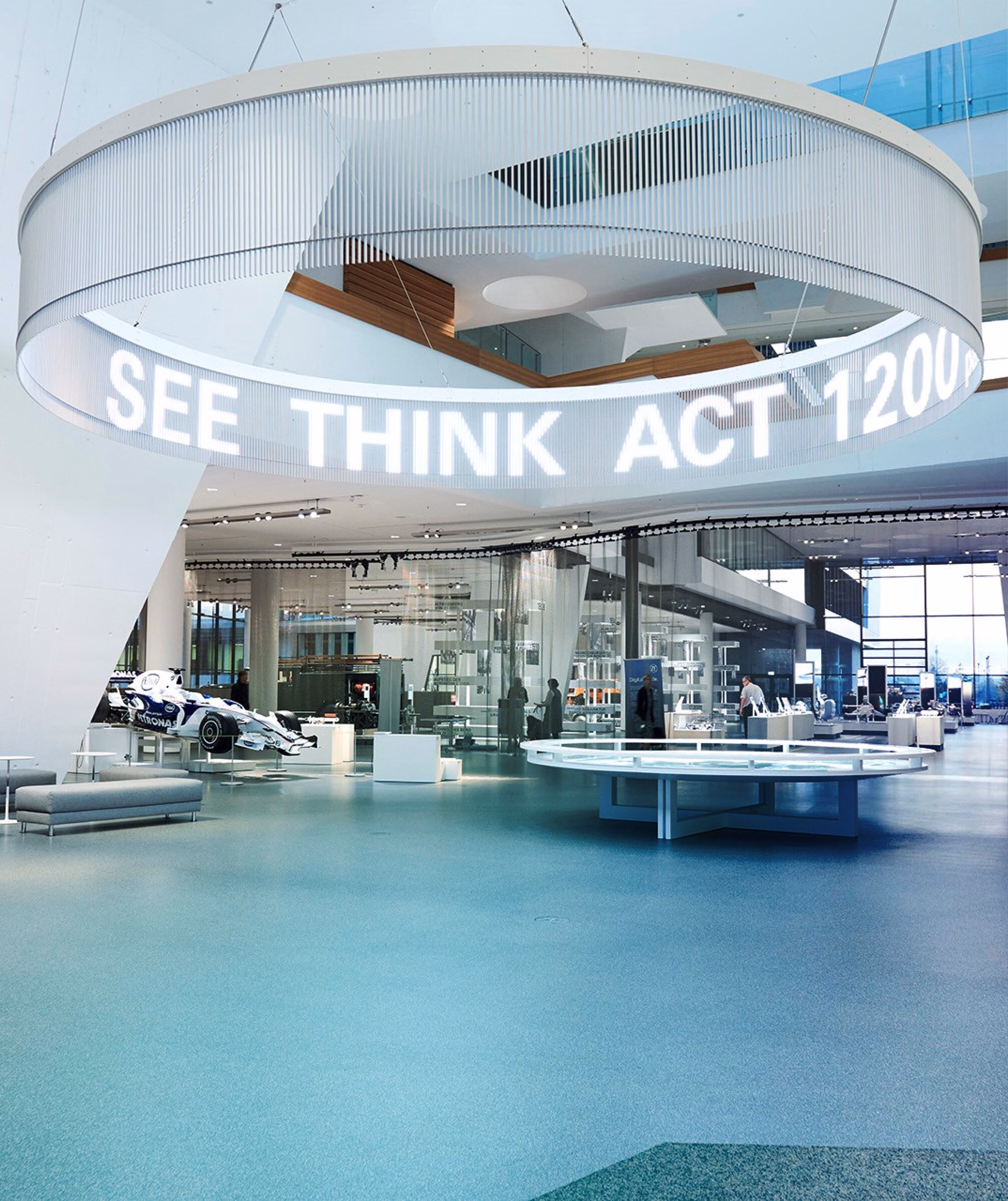 Immersive automotive exhibition hall with suspended digital display