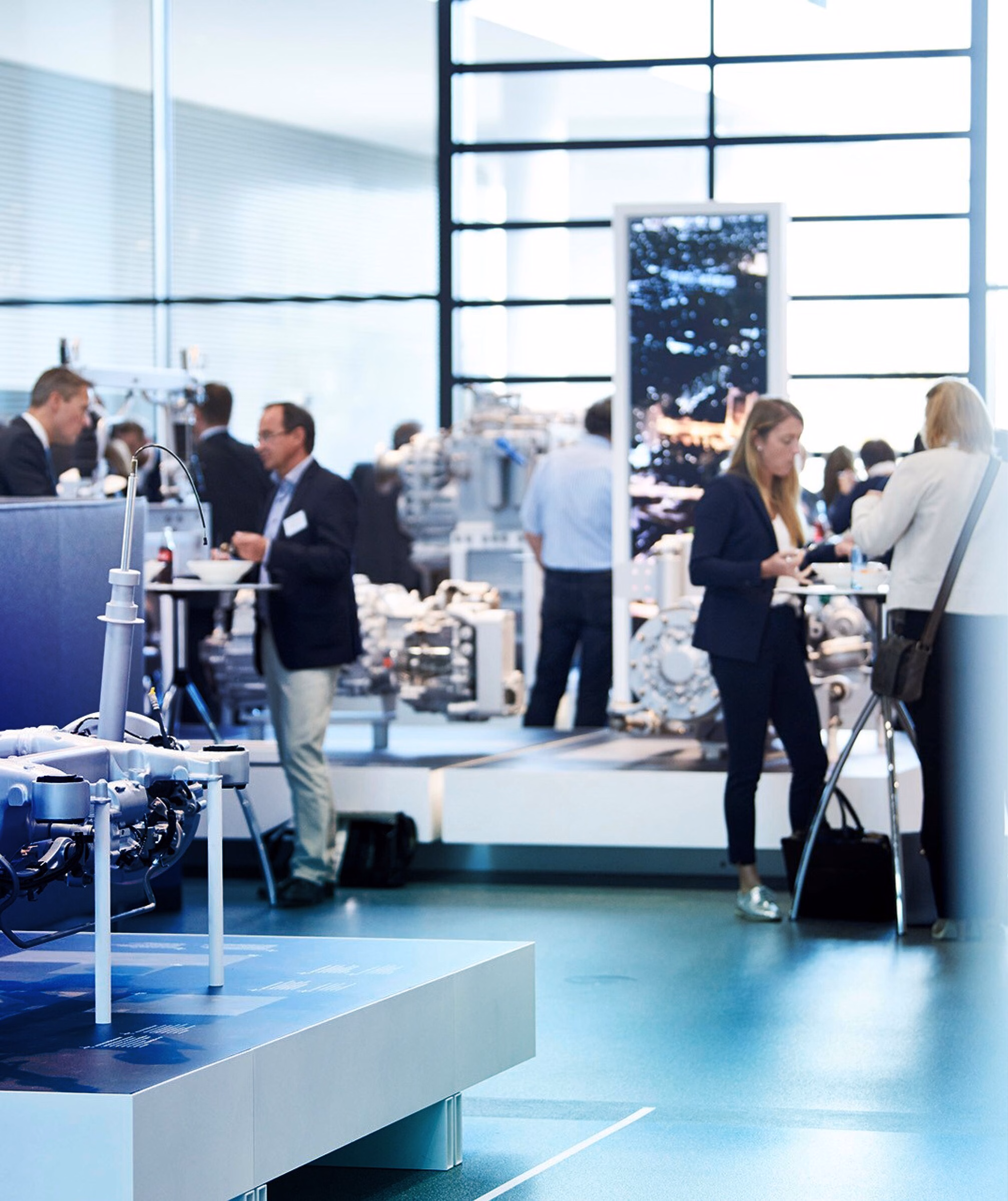 Visitors holding conversations among ZF automotive displays